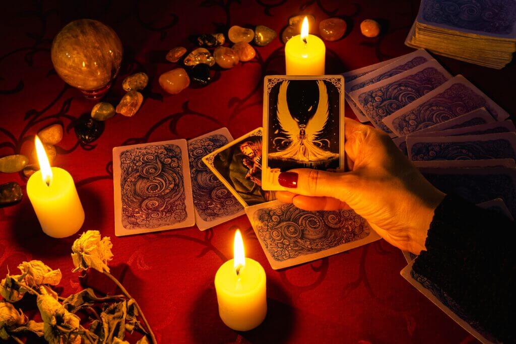 MINSK, BELARUS - November 2021: A fortune teller reads tarot cards and holds a justice card in her h